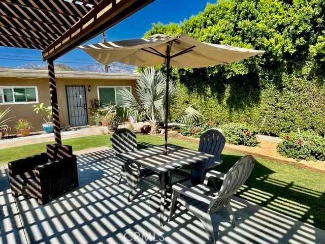 a view of a patio with a table chairs and a potted plant
