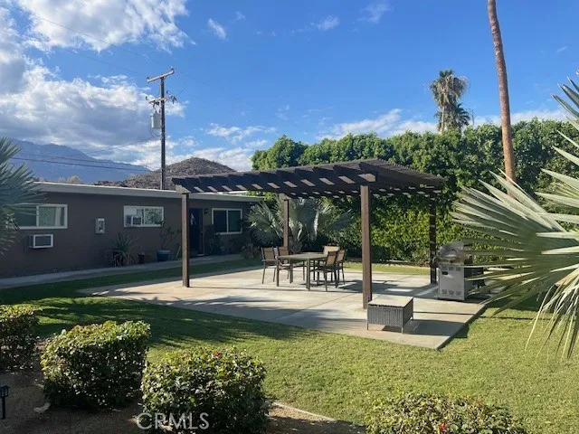 a swimming pool with outdoor seating and yard