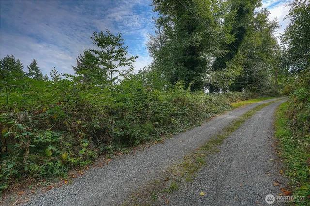 an aerial view of a house with a yard and garden