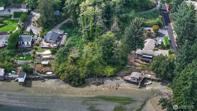 an aerial view of a house with a yard and lake view