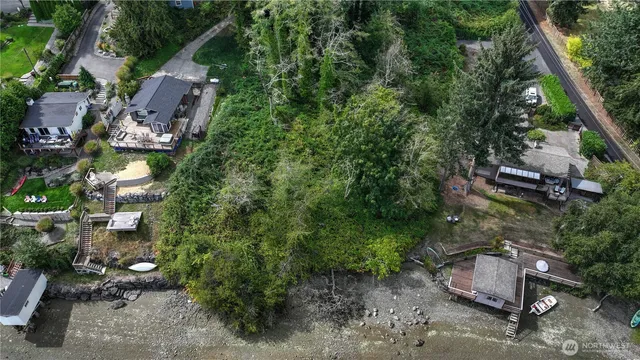 an aerial view of a house with a yard basket ball court and outdoor seating