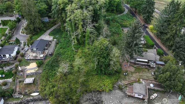an aerial view of a house with a yard and lake view