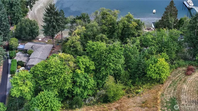 an aerial view of a house with a yard and outdoor seating