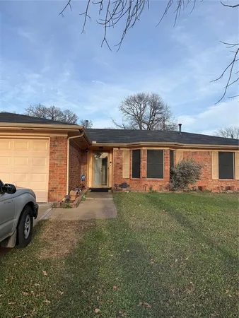 a view of a house with a large space and a car parked in front of it