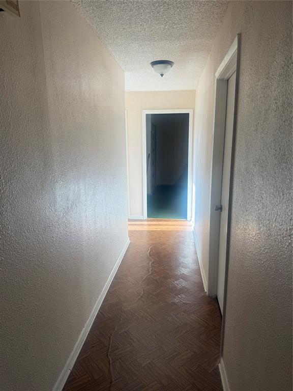 1117 Victoria Street Bellmead, TX 76705 - Photo 7 of 11 Hallway featuring a textured wall and a textured ceiling
