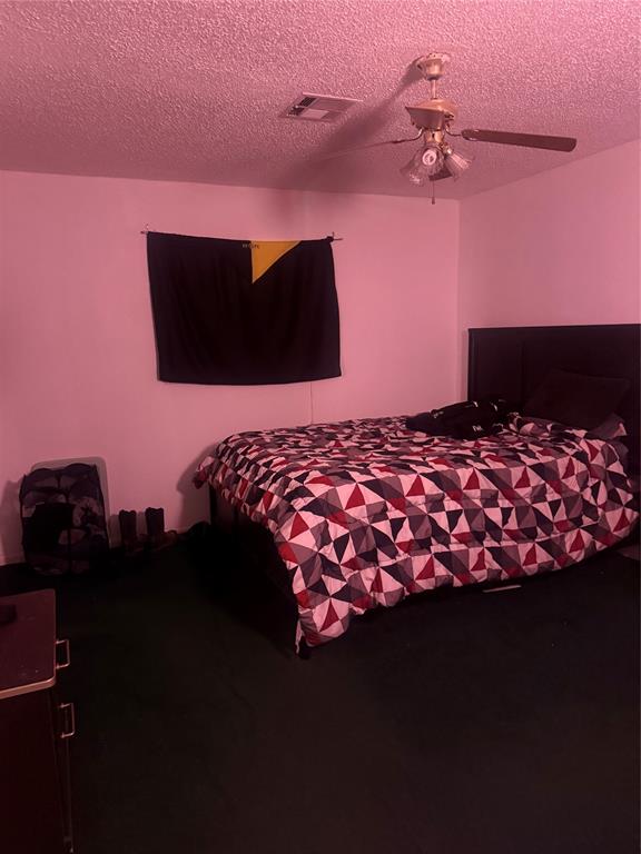 1117 Victoria Street Bellmead, TX 76705 - Photo 9 of 11 Bedroom with ceiling fan and a textured ceiling