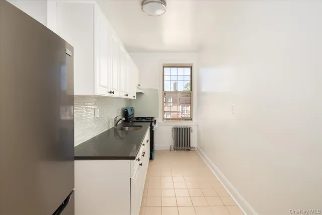 a kitchen with a refrigerator a stove a microwave and cabinets