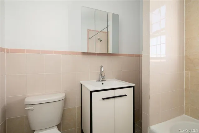 a bathroom with a toilet a sink and a mirror