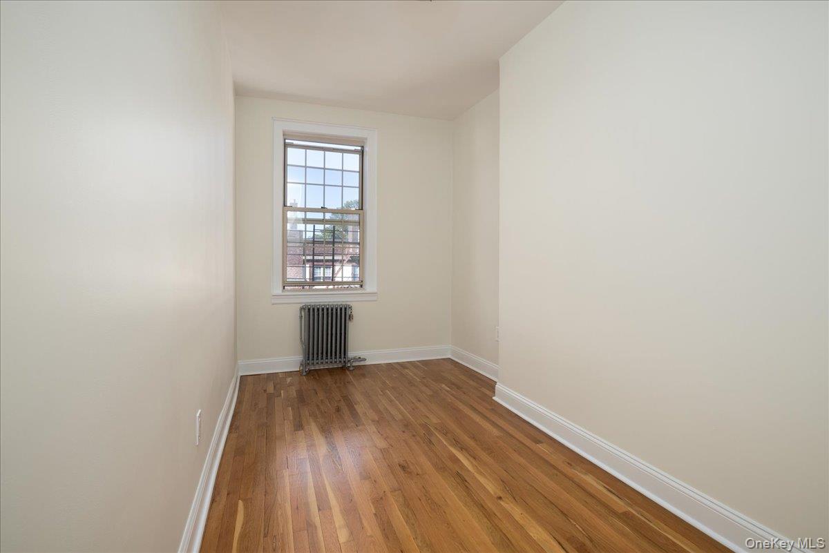 83-09 Talbot, Unit 6L Queens, NY 11415 - Photo 7 of 19 wooden floor in an empty room with a window