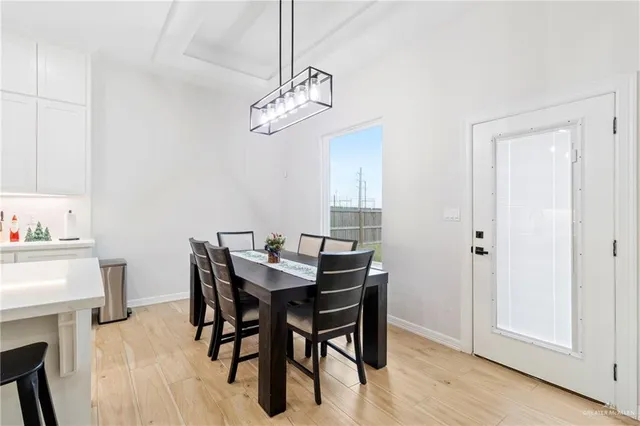 a view of a dining room with furniture wooden floor and a chandelier