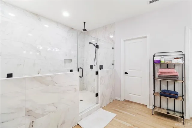 a bathroom with a bathtub and a shower