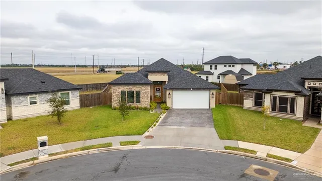 an aerial view of a house with a ocean view