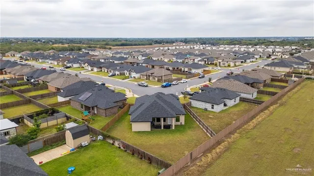 an aerial view of residential houses with outdoor space and swimming pool