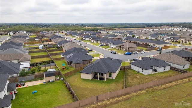 an aerial view of a house with a swimming pool yard and outdoor seating