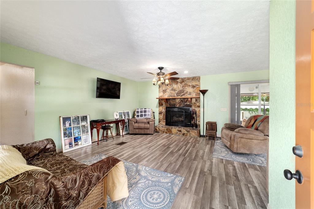 15755 Southwest 90th Avenue Dunnellon, FL 34432 - Photo 8 of 55 a bedroom with furniture and a fireplace