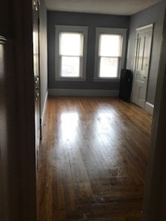 7 Willow Street Holyoke, MA 01040 - Photo 17 of 33 an empty room with wooden floor and windows