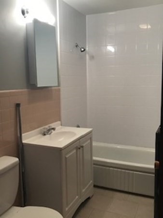 7 Willow Street Holyoke, MA 01040 - Photo 20 of 33 a bathroom with a sink toilet vanity and tub