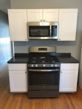 7 Willow Street Holyoke, MA 01040 - Photo 22 of 33 a stove top oven sitting inside of a kitchen