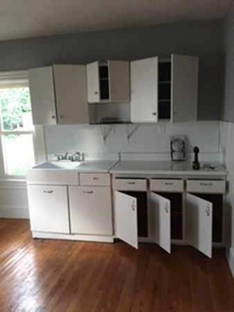 7 Willow Street Holyoke, MA 01040 - Photo 23 of 33 a kitchen with stainless steel appliances white cabinets and a sink