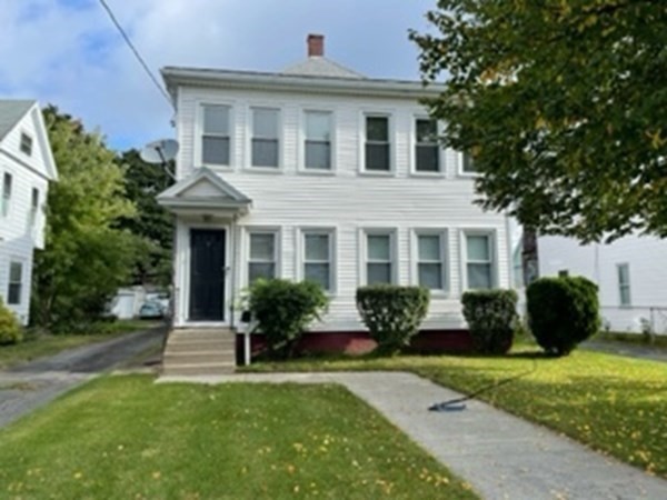 7 Willow Street Holyoke, MA 01040 - Photo 3 of 33 a front view of a house with a garden and plants