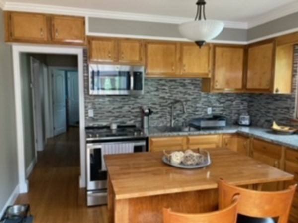 7 Willow Street Holyoke, MA 01040 - Photo 6 of 33 a kitchen with a sink and a stove