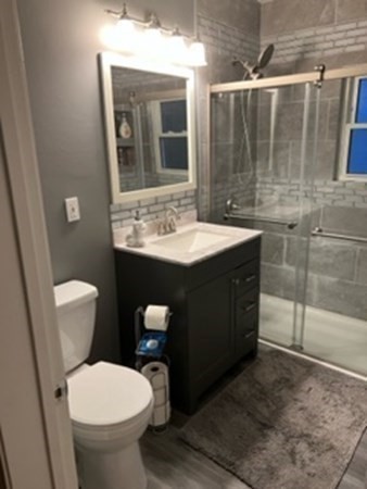 7 Willow Street Holyoke, MA 01040 - Photo 9 of 33 a bathroom with a toilet sink and mirror