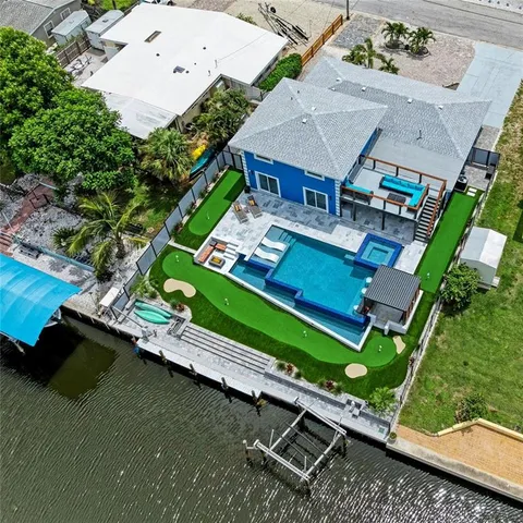 an aerial view of a house with a garden and swimming pool