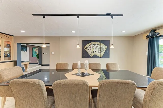 a bedroom with a large bed and a flat tv screen