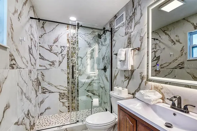 a living room with furniture a ceiling fan and a window