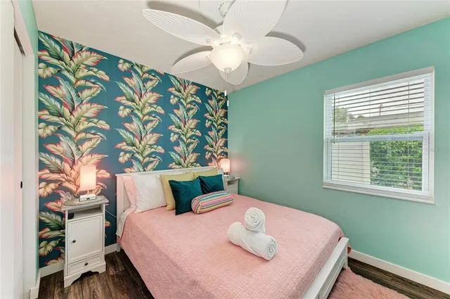 a bedroom with a bed and a large mirror