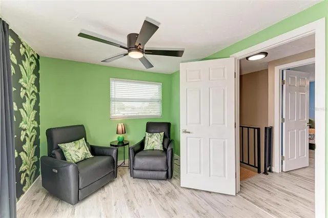 a swimming pool with outdoor seating and plants