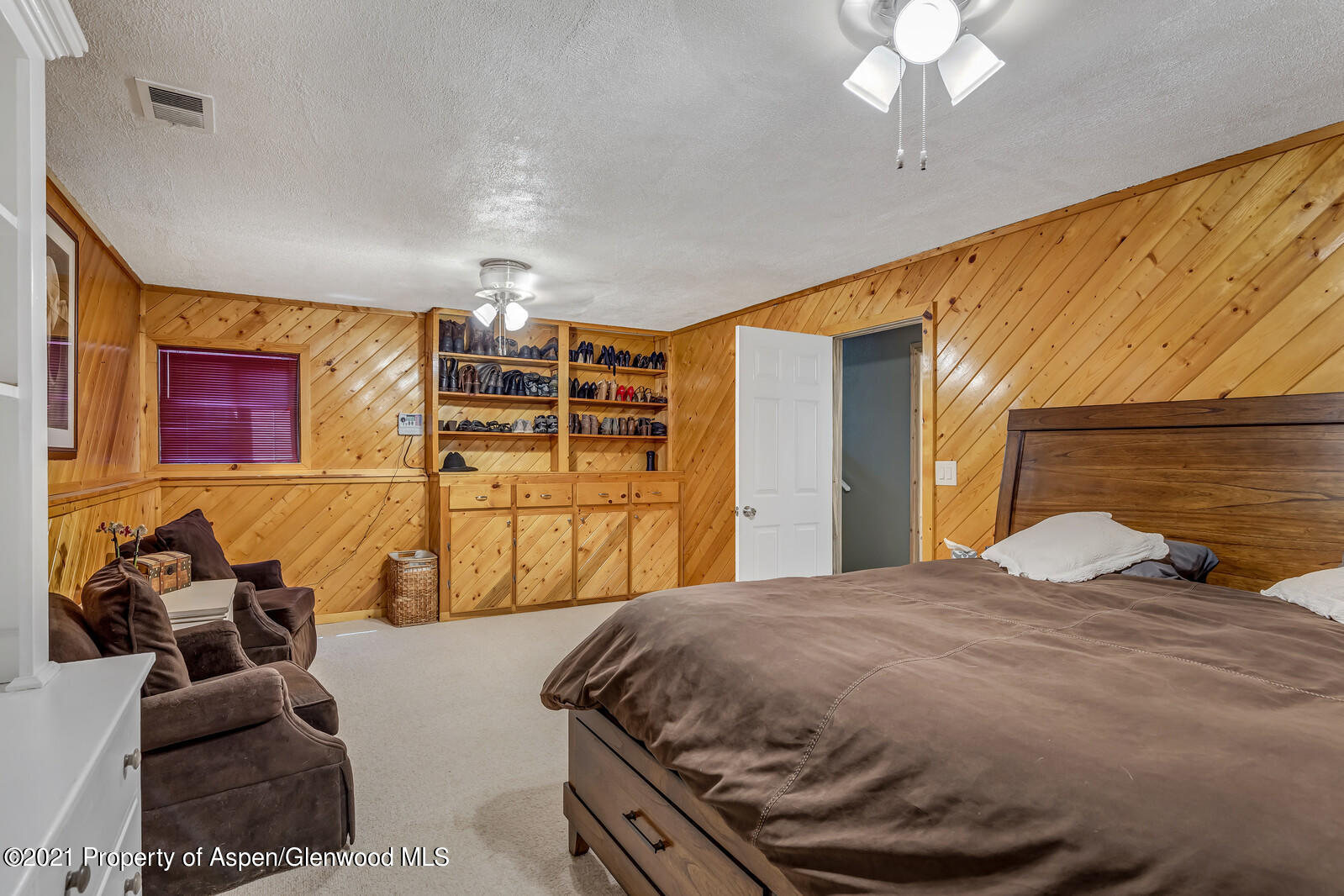 511 Fairway Avenue Rifle, CO 81650 - Photo 11 of 17 a bedroom with a bed and ceiling fan