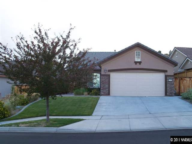 1219 Firefly Court Reno, NV 89523 - Photo 1 of 1 a front view of house with garage and yard