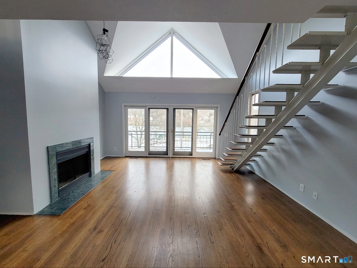 wooden floor in an empty room with a fireplace