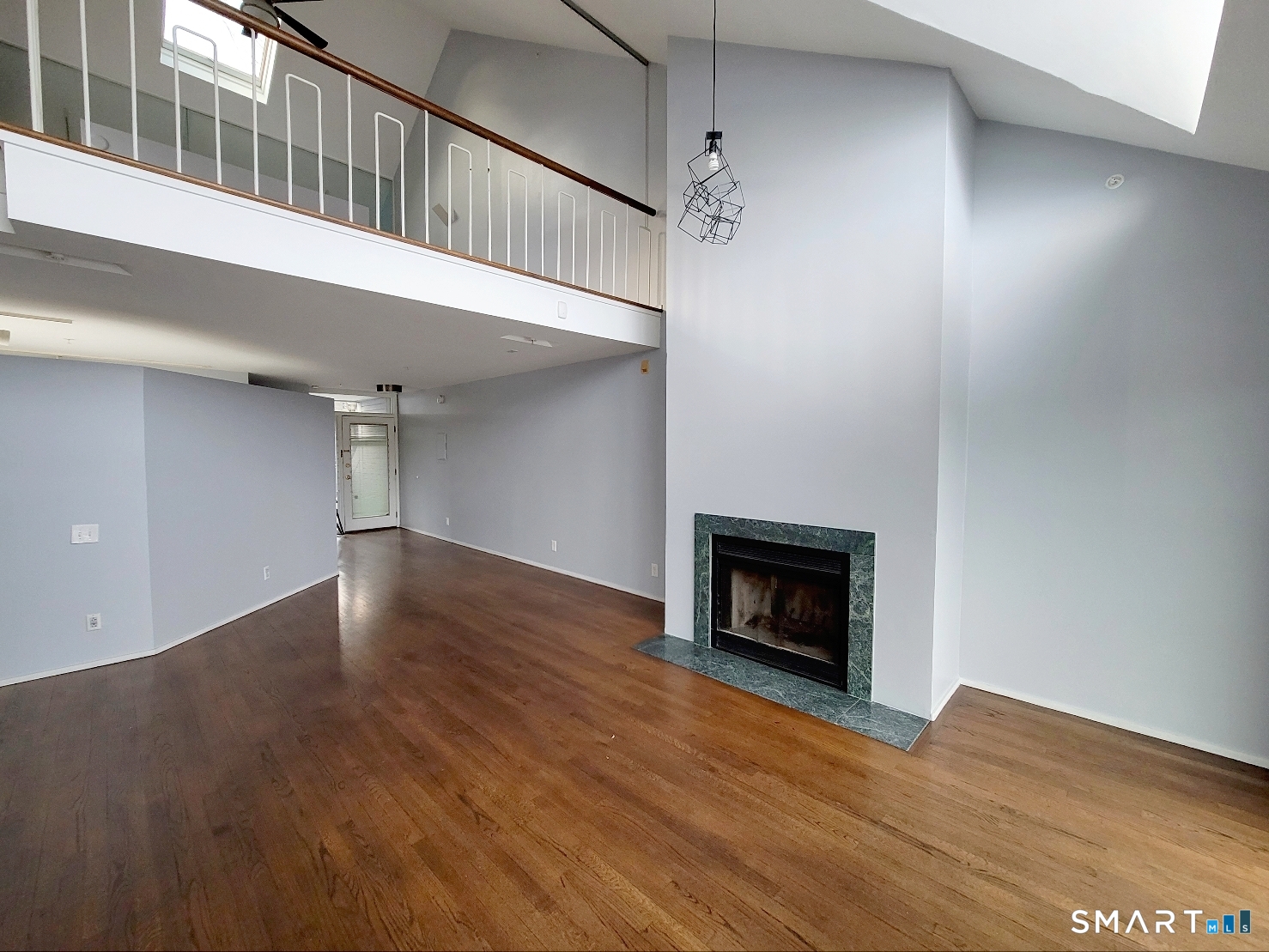 2 Front Street, Unit 2J New Haven, CT 06513 - Photo 3 of 15 a view of an empty room with wooden floor fireplace and a window