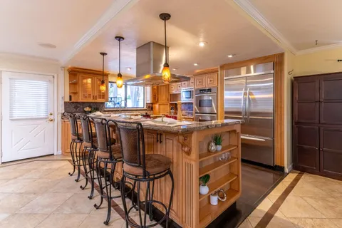 a living room with furniture kitchen view and a table