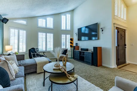 a view of a workspace with furniture and a window
