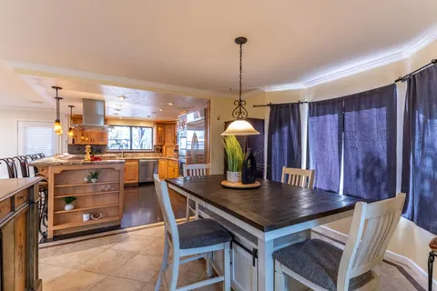 a view of a house with a small yard and floor to ceiling window