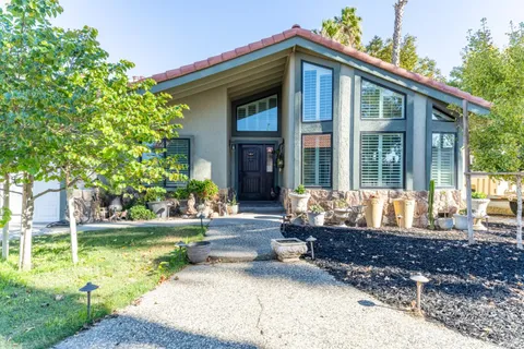 a front view of a house with a potted plant