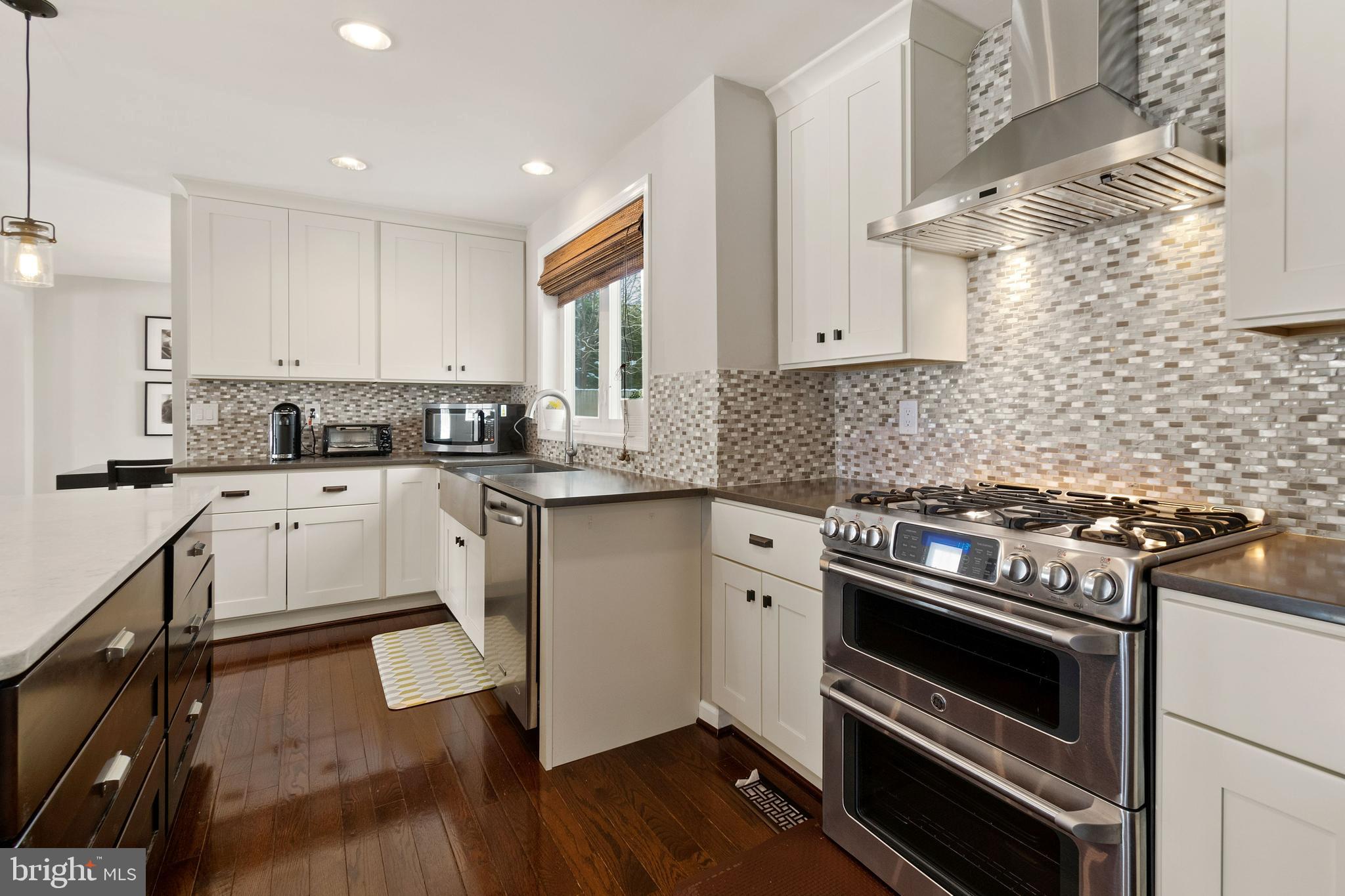 11600 Coldstream Drive Potomac, MD 20854 - Photo 11 of 25 a kitchen with granite countertop cabinets stainless steel appliances and wooden floor