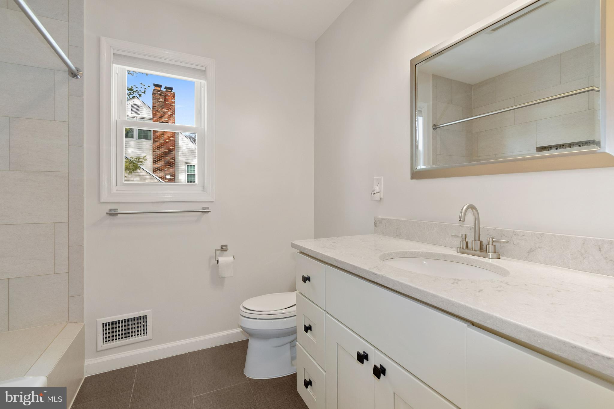 11600 Coldstream Drive Potomac, MD 20854 - Photo 16 of 25 a bathroom with a granite countertop toilet sink and mirror