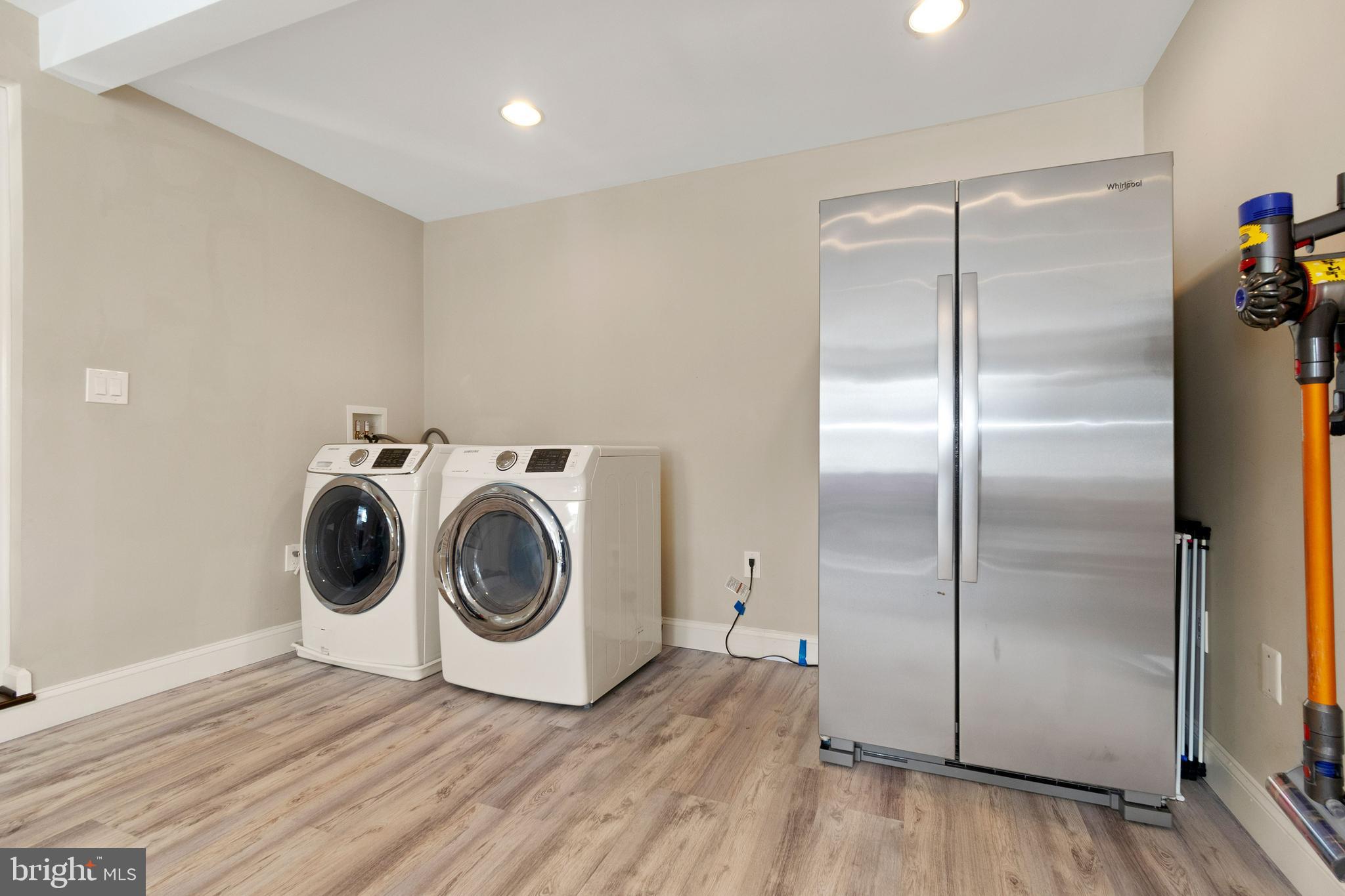 11600 Coldstream Drive Potomac, MD 20854 - Photo 19 of 25 a view of washer and dryer with wooden floor
