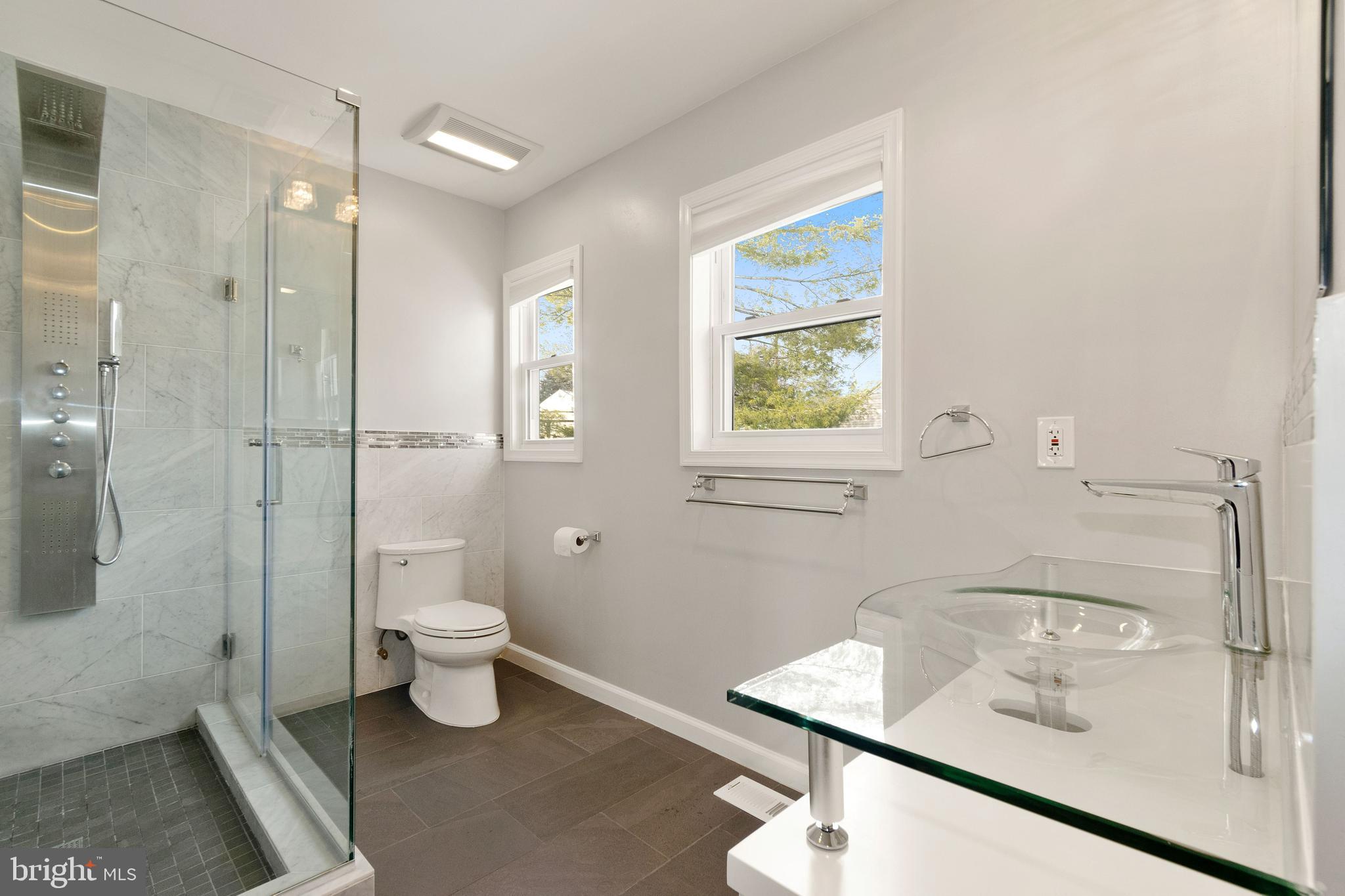 11600 Coldstream Drive Potomac, MD 20854 - Photo 20 of 25 a bathroom with a granite countertop sink a toilet and shower