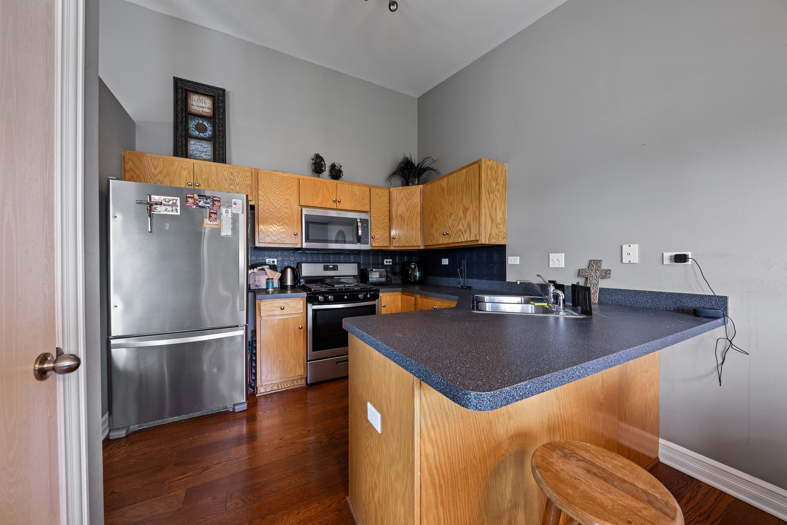 8331 Chestnut Court Frankfort, IL 60423 - Photo 4 of 15 a kitchen with stainless steel appliances granite countertop a refrigerator a stove and a sink with wooden floor