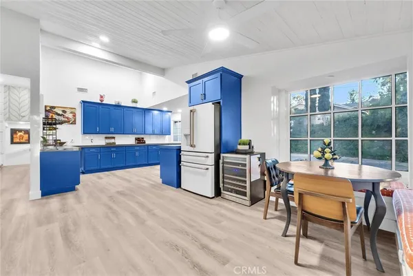 a kitchen with refrigerator and chairs