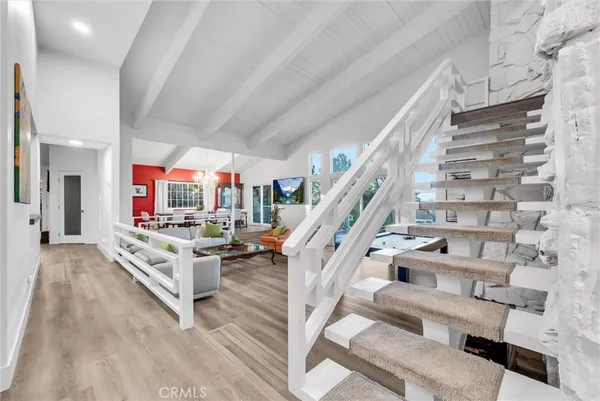 a view of entryway livingroom and hall with wooden floor