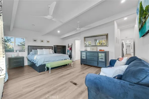a bedroom with a bed window and couch