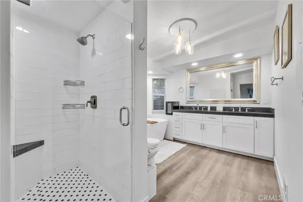 a large white bathroom with a granite countertop sink