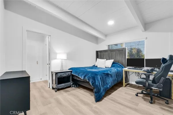 a bedroom with a bed a desk and chair