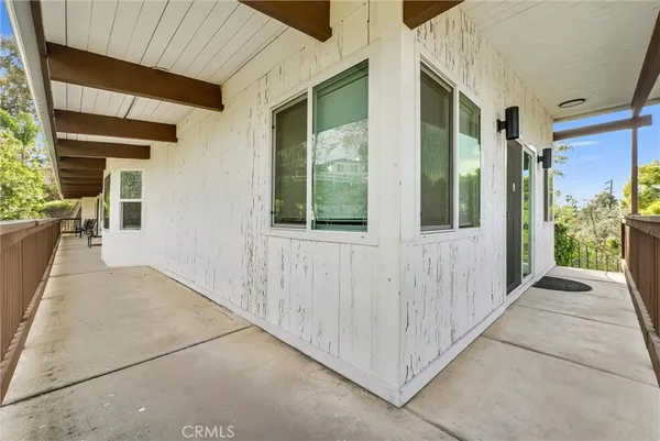 a view of a porch with wooden floor and stairs